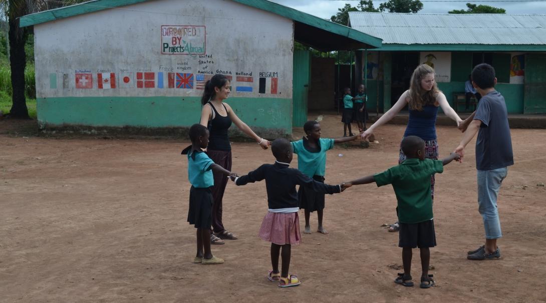 On a Projects Abroad Public Health group Internship in Ghana, interns spend time playing with children at a placement. Interns take a break from their Public health work in Ghana for groups, to play with young children at their placement.
